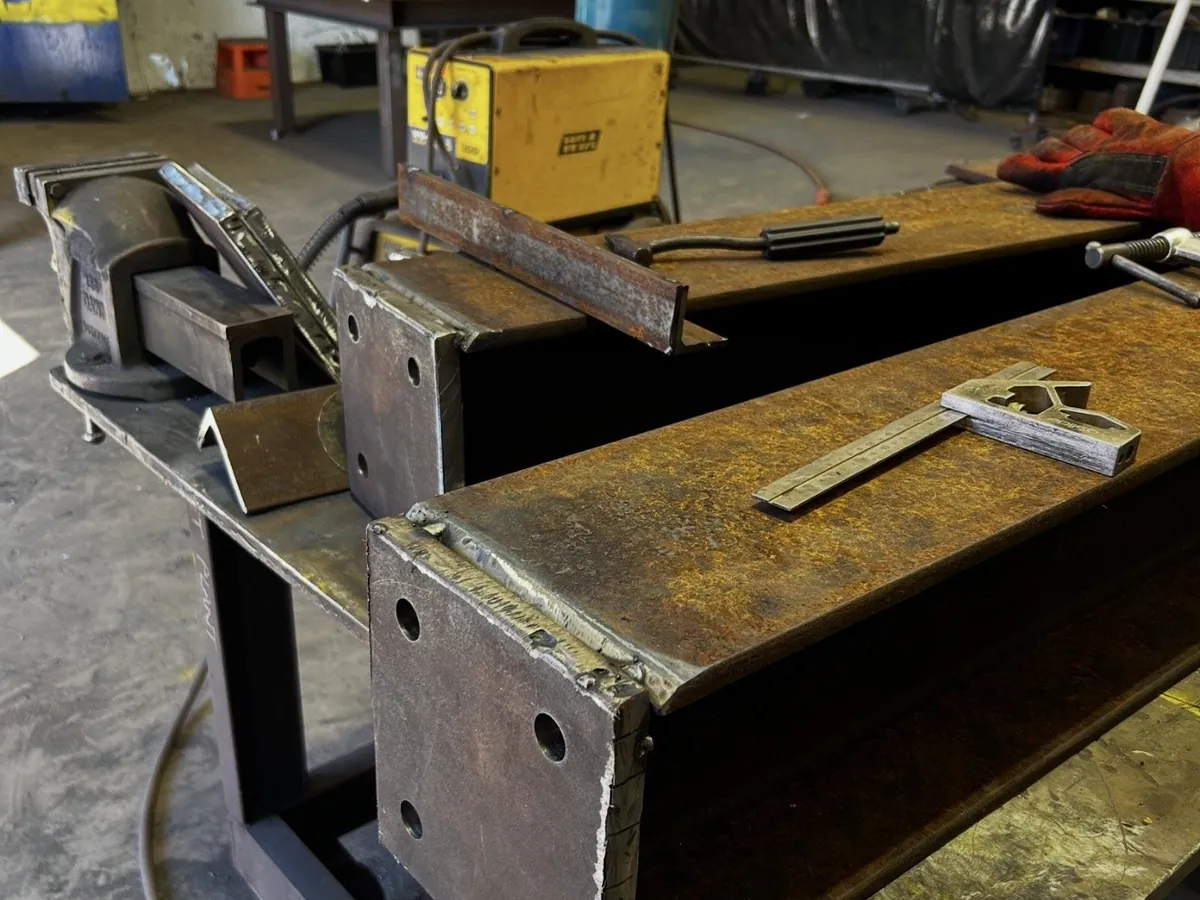 Plant & Fixed workshop bench with steel components, tools and welding equipment